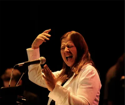 DB Singing in front of a crowd eyes closed